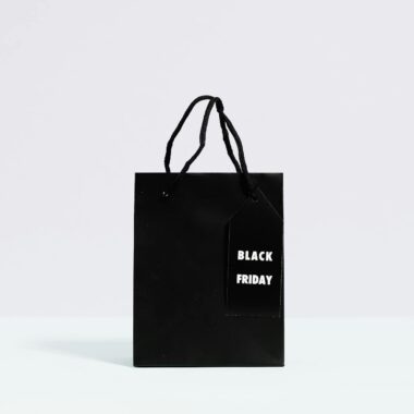 Black Friday shopping bag displayed on a minimalist background, perfect for sale promotions.
